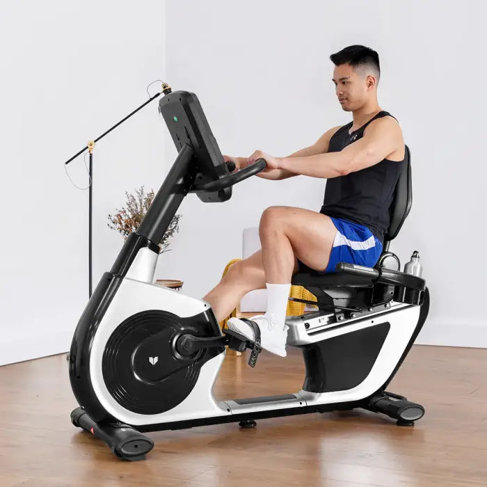 RBX100 recumbent bike in a room with a man exercising on the bike