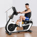 RBX100 recumbent bike in a room with a man exercising on the bike