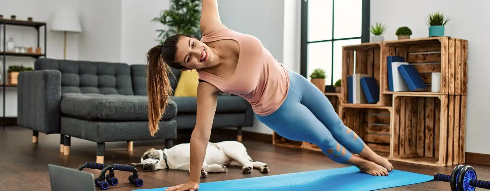 A woman in athletic wear performing a side plank exercise.